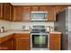 This kitchen is equipped with stainless steel appliances and beautiful wood cabinets at 973 E Kelsi Ave, San Tan Valley, AZ 85140