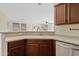 Bright kitchen featuring granite countertops, stainless steel appliances, and wood cabinets at 973 E Kelsi Ave, San Tan Valley, AZ 85140