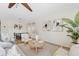 Bright living room featuring a ceiling fan, neutral color palette, and a cozy seating area with lots of natural light at 973 E Kelsi Ave, San Tan Valley, AZ 85140