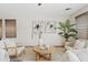 Bright living room featuring neutral decor, a round coffee table, and plants at 973 E Kelsi Ave, San Tan Valley, AZ 85140