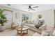Bright living room featuring a comfy couch, neutral decor, and a round coffee table at 973 E Kelsi Ave, San Tan Valley, AZ 85140