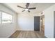 Spacious bedroom featuring modern flooring, a ceiling fan, and a bright window offering outdoor views at 1017 E Diana Ave, Phoenix, AZ 85020