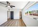 Well-lit bedroom featuring a ceiling fan, modern flooring, and a large window with outdoor views at 1017 E Diana Ave, Phoenix, AZ 85020