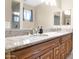 Bathroom featuring a double sink vanity with granite countertops and well-lit mirrors at 10536 W Villa Hermosa --, Peoria, AZ 85383