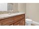 Bathroom featuring a granite countertop, wooden cabinets, toilet, and neutral walls at 10536 W Villa Hermosa --, Peoria, AZ 85383