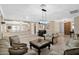 Spacious living room with tile floors, comfortable seating, and stylish light fixture at 10536 W Villa Hermosa --, Peoria, AZ 85383