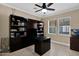 Home office with custom built-in shelving, a desk, and a window for natural light at 10536 W Villa Hermosa --, Peoria, AZ 85383