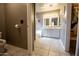Tiled bathroom featuring double vanity with walk-in closet at 11022 N 60Th Dr, Glendale, AZ 85304