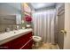 Cozy full bathroom featuring a striking red vanity at 11022 N 60Th Dr, Glendale, AZ 85304