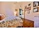 Comfortable bedroom with wooden floors and a collection of artwork at 11022 N 60Th Dr, Glendale, AZ 85304