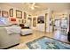 Spacious living room featuring a large blue rug, and plentiful decorative mirrors at 11022 N 60Th Dr, Glendale, AZ 85304