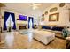 Bright living room with a fireplace, TV, tile floors, and comfortable seating at 11022 N 60Th Dr, Glendale, AZ 85304