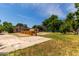 Large backyard featuring a spacious patio, landscaping and mature trees at 1134 W 2Nd St, Mesa, AZ 85201