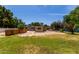 Grassy backyard featuring a spacious patio, mature landscaping and shady trees at 1134 W 2Nd St, Mesa, AZ 85201