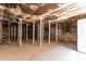 Basement view with supporting posts, open space, and a door for potential customization at 1134 W 2Nd St, Mesa, AZ 85201