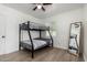Bedroom with ceiling fan features wood look floors, a bunk bed and a large standing mirror at 1134 W 2Nd St, Mesa, AZ 85201
