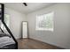 Bedroom showcases wood flooring, a full length mirror, a bunk bed and natural light from the window at 1134 W 2Nd St, Mesa, AZ 85201