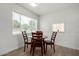 Cozy dining room with a round wooden table, seating for four, and natural light from the windows at 1134 W 2Nd St, Mesa, AZ 85201