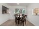 Bright dining room with wood-style flooring, round table, four chairs, and convenient pass-through at 1134 W 2Nd St, Mesa, AZ 85201