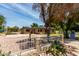 Wide view of the house, showing a covered parking area behind the home and desert landscaping at 1134 W 2Nd St, Mesa, AZ 85201