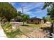 Side view of a well-maintained single-story home with desert landscaping and a white picket fence at 1134 W 2Nd St, Mesa, AZ 85201