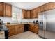 Modern kitchen featuring stainless steel appliances, wood cabinetry, and granite countertops at 1134 W 2Nd St, Mesa, AZ 85201