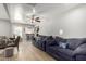 Spacious living room features a ceiling fan, wood-style flooring, and comfortable couches for relaxing at 1134 W 2Nd St, Mesa, AZ 85201