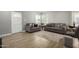 Bright living room featuring stylish gray sofas, light wood floors, and a decorative doorway at 1134 W 2Nd St, Mesa, AZ 85201
