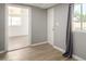 Room with a open doorway, wood look floors, and an exterior access door and window at 1134 W 2Nd St, Mesa, AZ 85201