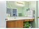 Well-lit bathroom with vanity, large mirror, and storage cabinets at 12422 W Rosewood Dr, El Mirage, AZ 85335