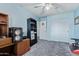 Another angle of the bedroom features carpet flooring, closet and a ceiling fan at 12422 W Rosewood Dr, El Mirage, AZ 85335