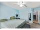 Cozy bedroom featuring a ceiling fan, neutral carpet and a large closet at 12422 W Rosewood Dr, El Mirage, AZ 85335
