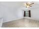 Bright bedroom with wood-look flooring, ceiling fan and window at 12422 W Rosewood Dr, El Mirage, AZ 85335
