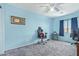 Spacious bedroom featuring large window, light blue paint and carpet flooring at 12422 W Rosewood Dr, El Mirage, AZ 85335