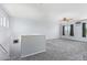 Spacious bonus room features plush carpeting, a ceiling fan, and natural light at 12422 W Rosewood Dr, El Mirage, AZ 85335