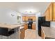 Open kitchen with wooden cabinets, black appliances, and tiled flooring at 12422 W Rosewood Dr, El Mirage, AZ 85335
