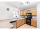 Updated kitchen with wood cabinetry, stainless steel dishwasher and tile flooring at 12422 W Rosewood Dr, El Mirage, AZ 85335
