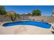 Sparkling blue pool surrounded by a patio and block wall for privacy at 12422 W Rosewood Dr, El Mirage, AZ 85335