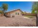 A spacious backyard featuring low maintenance landscaping with gravel and a block wall fence, perfect for outdoor living at 13241 W Desert Ln, Surprise, AZ 85374