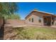 Backyard view showcasing the home's exterior and surrounding greenery at 13241 W Desert Ln, Surprise, AZ 85374