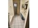 Well-lit bathroom featuring a bathtub, a single sink vanity with drawers, and a white tile floor at 13241 W Desert Ln, Surprise, AZ 85374