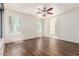 Spacious bedroom boasts hardwood floors, a ceiling fan, recessed lighting, and natural light at 13241 W Desert Ln, Surprise, AZ 85374