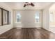 Bedroom featuring hardwood floors and views of the bright outdoors at 13241 W Desert Ln, Surprise, AZ 85374