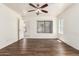 Large bedroom with wood floors, natural light, and access to the en suite bathroom at 13241 W Desert Ln, Surprise, AZ 85374