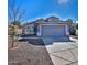 Charming single-story home with a well-manicured front yard, tile roof, and a two-car garage at 13241 W Desert Ln, Surprise, AZ 85374