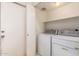 Laundry room featuring washer and dryer machines and a storage shelf above at 13241 W Desert Ln, Surprise, AZ 85374