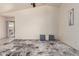 The bright living room features neutral walls, tile flooring, and large windows at 13241 W Desert Ln, Surprise, AZ 85374