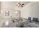 Bright living room featuring tile flooring, a ceiling fan, and neutral walls for versatile decorating at 13241 W Desert Ln, Surprise, AZ 85374