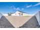Home with a spacious backyard that includes rock landscaping and white block fence at 14178 S Diablo Rd, Arizona City, AZ 85123