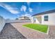 Spacious backyard features rock landscaping, a small patch of grass, and a white block fence at 14178 S Diablo Rd, Arizona City, AZ 85123